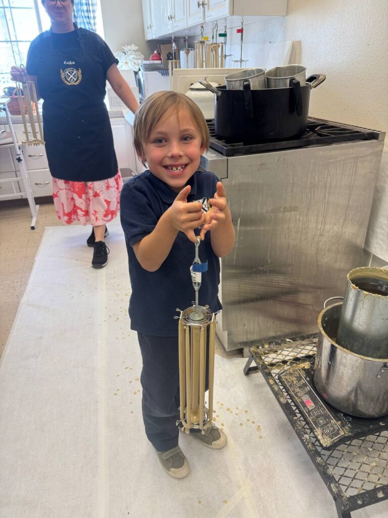 Our young ones making beeswax candles.